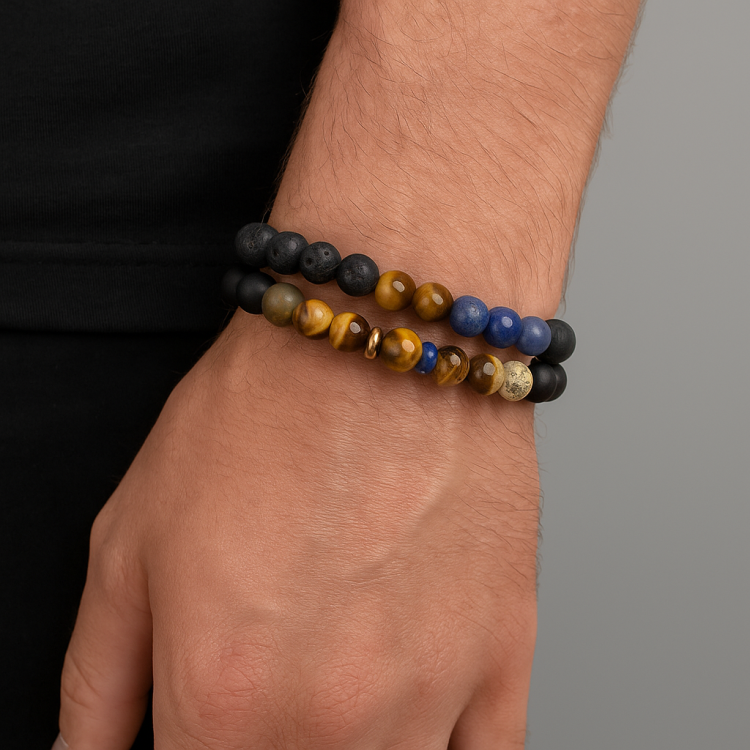 Wrap around multi stone beaded bracelet on wrist, featuring agate, hematite, tiger eye, lapis lazuli, jasper, lava beads, and rose gold Balinese bead.